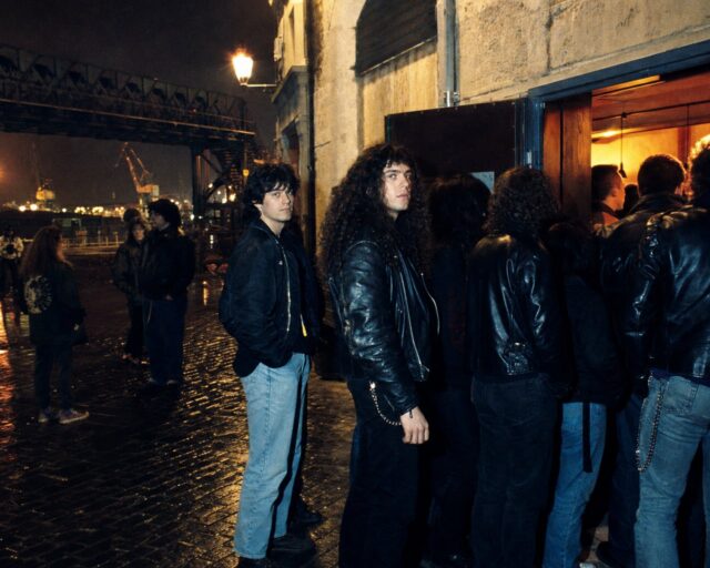 Público haciendo cola de noche ante una sala de conciertos en un barrio industrial de Bilbao
